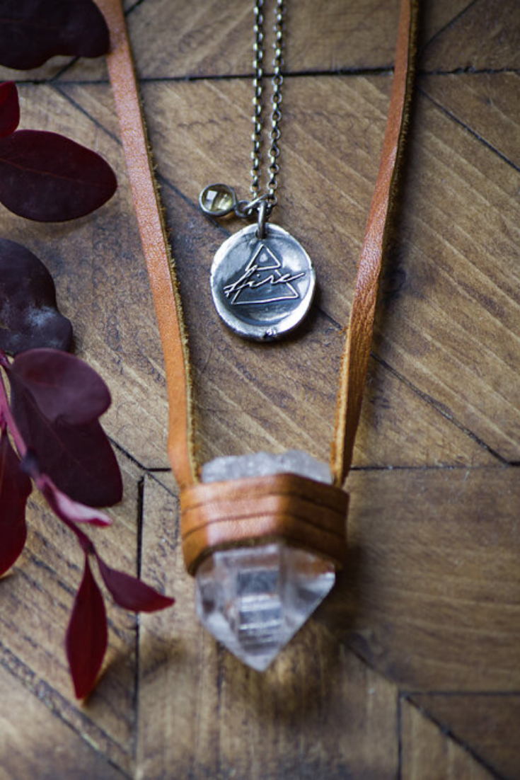 raw stone and leather necklace with rustic silver fire talisman medallion