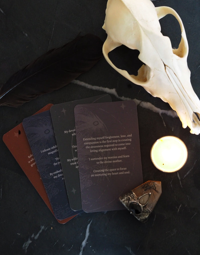 oracle tarot cards with skull, crystals, and candle