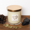 soy candle with black gemstone on wooden tray