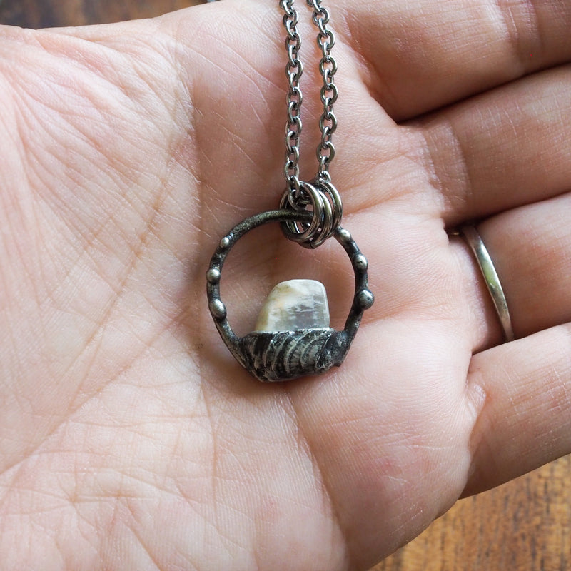 white moonstone healing crystal talisman necklace  in palm of hand
