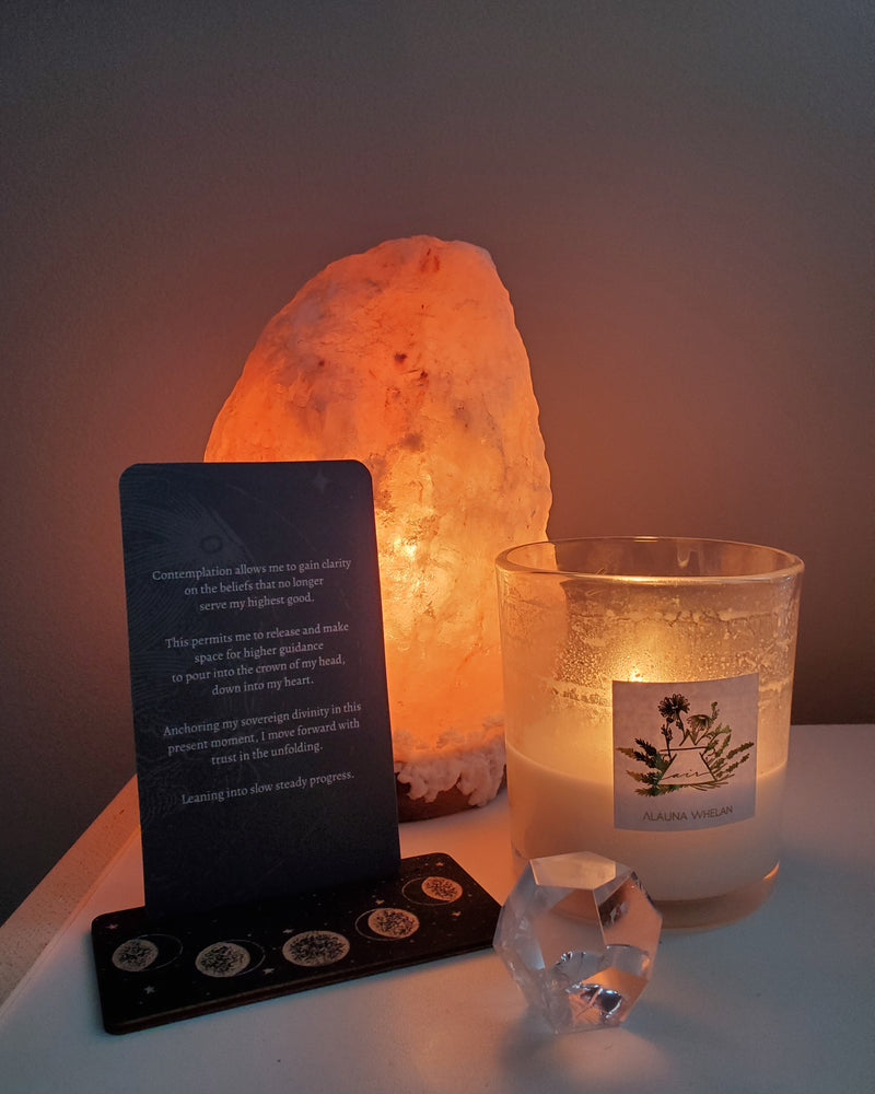 altar with salt lamp, oracle card, crystal, and luxury soy element candle