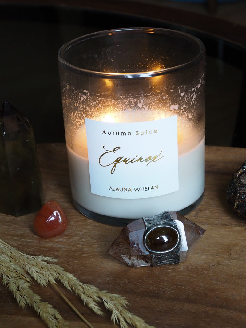 autumn equinox candle on altar with crystals and crystal wand
