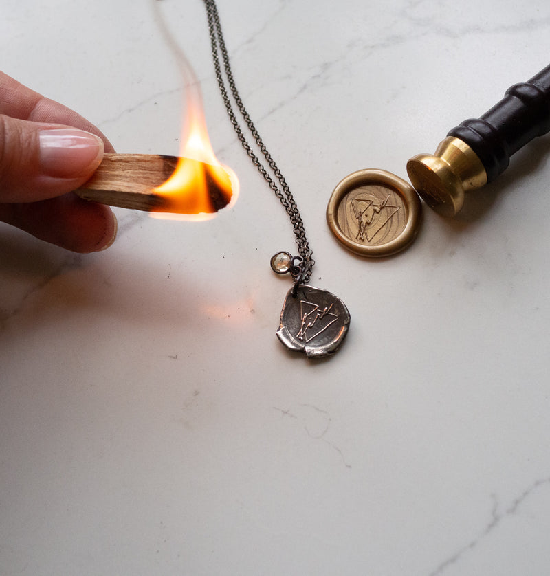 silver fire sign necklace with fire and wax seal
