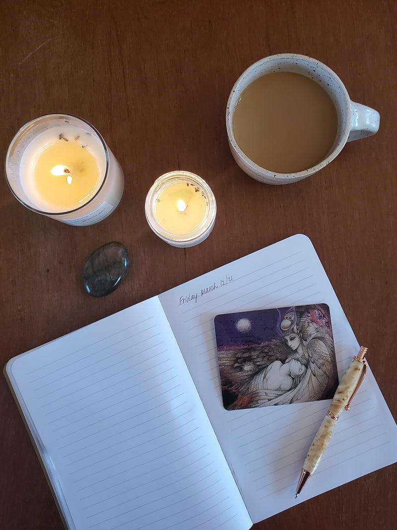 journal with candles crystals cards and coffee