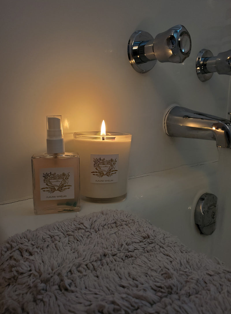 luxury soy candle and ritual mist on edge of bath tub