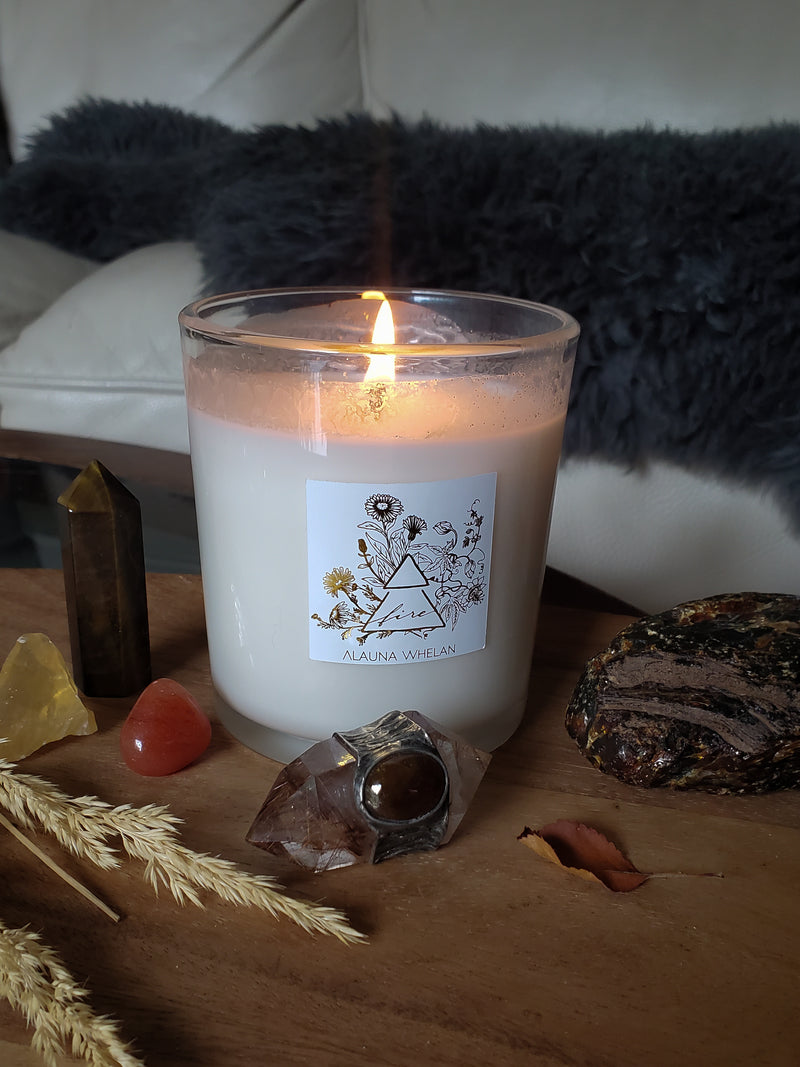 luxury hand-poured soy fire sign candle with crystals on wooden tray