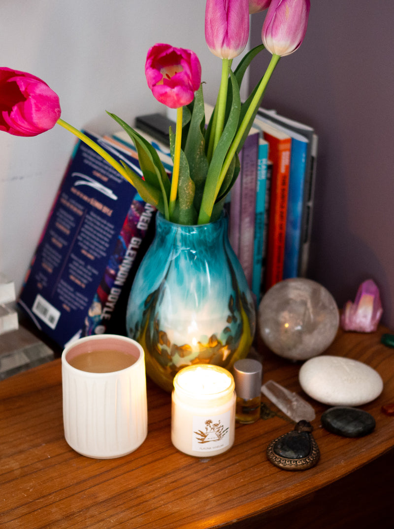 soy intention candle with tulips, crystals, and coffee