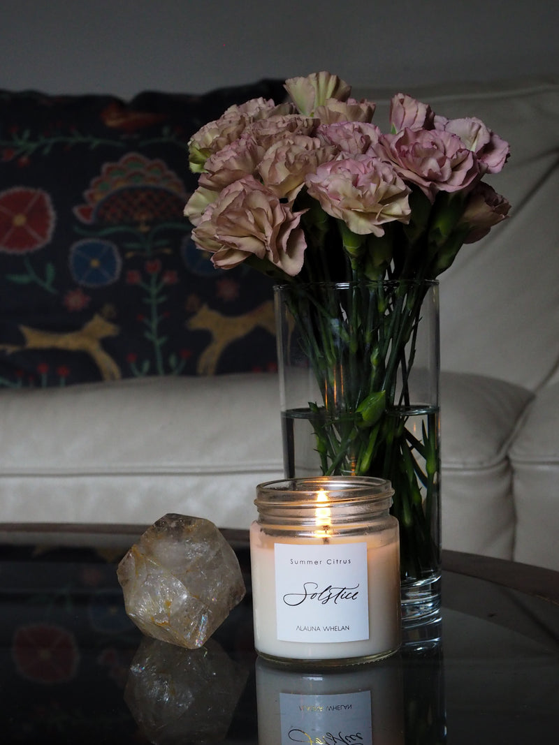 a few of my favorite things - summer solstice candle, vintage carnations, and crystals