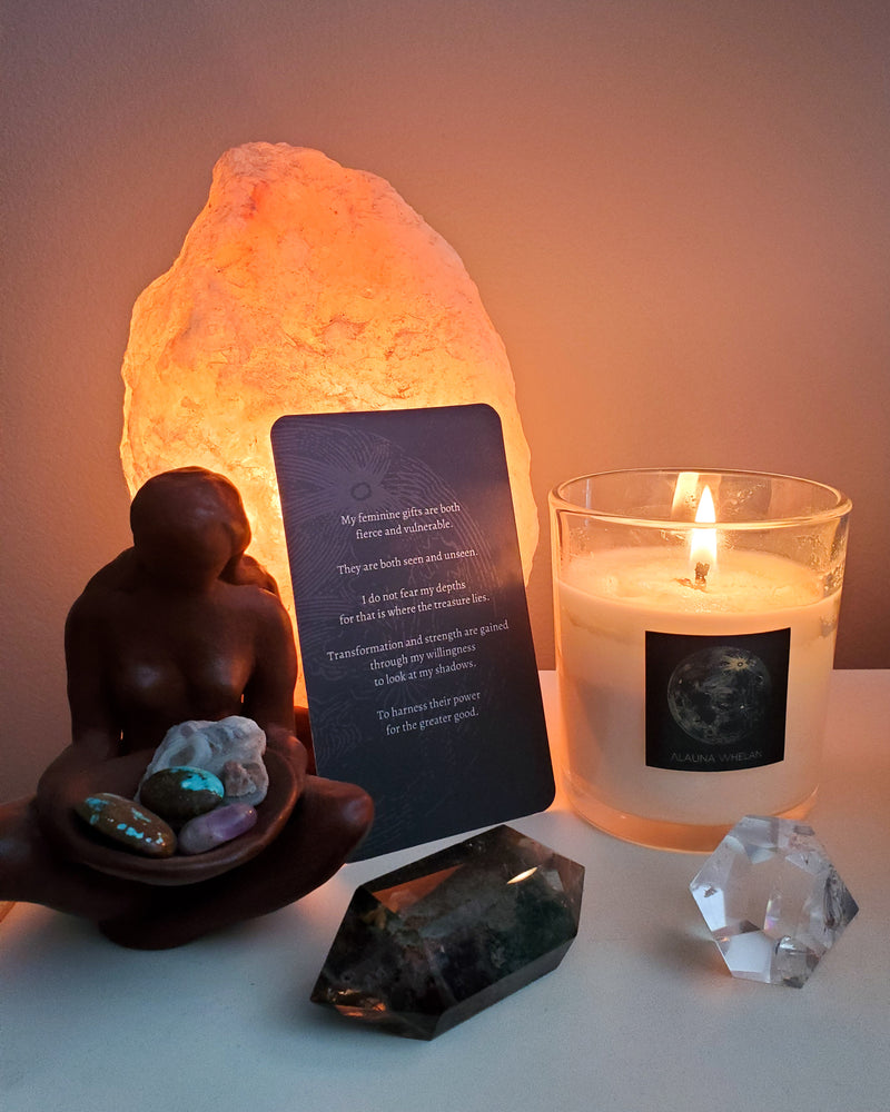 simple altar with crystals, goddess statue, oracle card, and luxury soy full moon candle