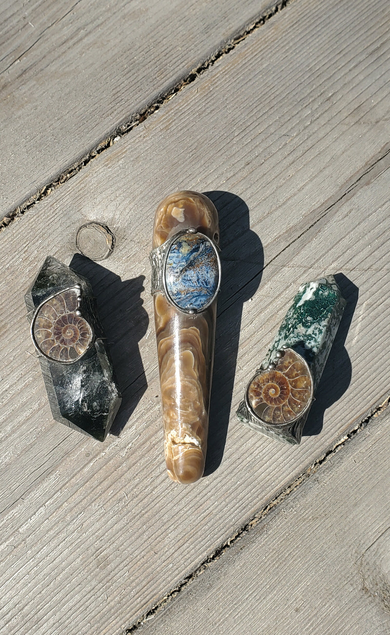 three healing crystal talisman ritual wands on wooden background