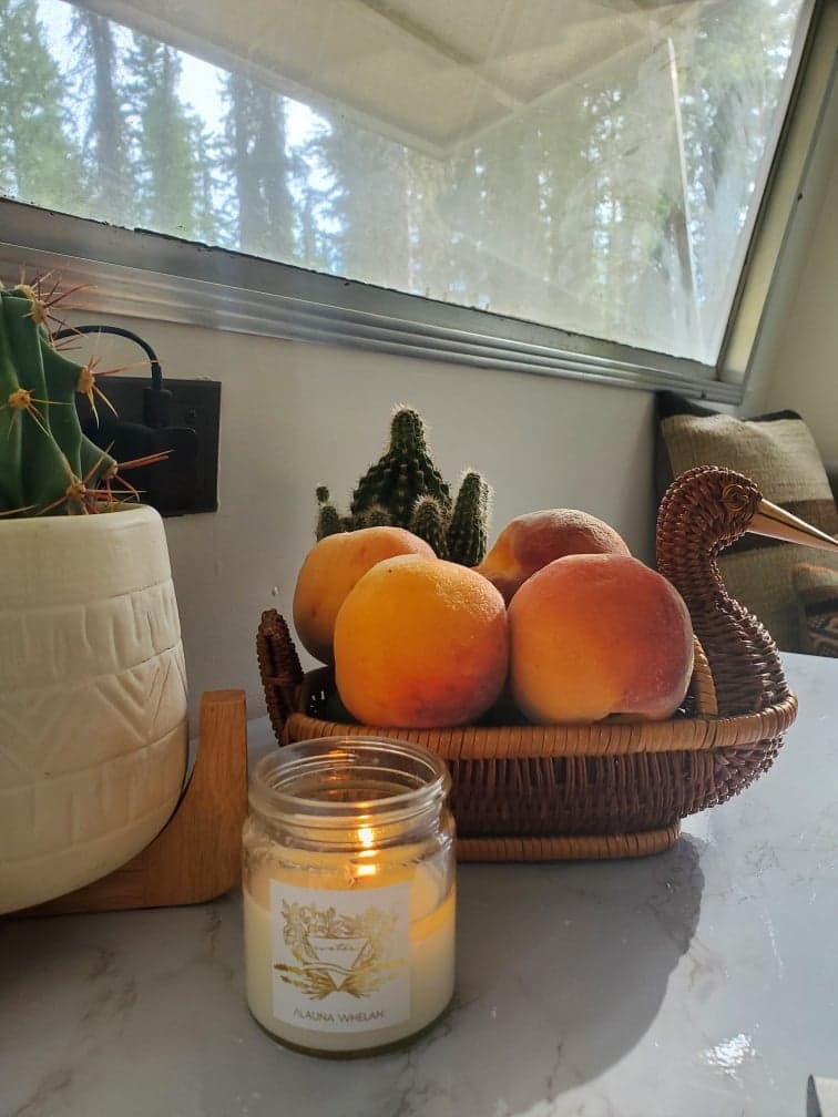 water candle with peaches on kitchen counter