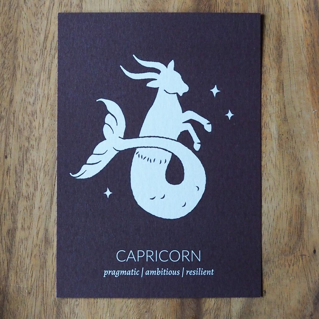 capricorn zodiac astrology print on wooden background