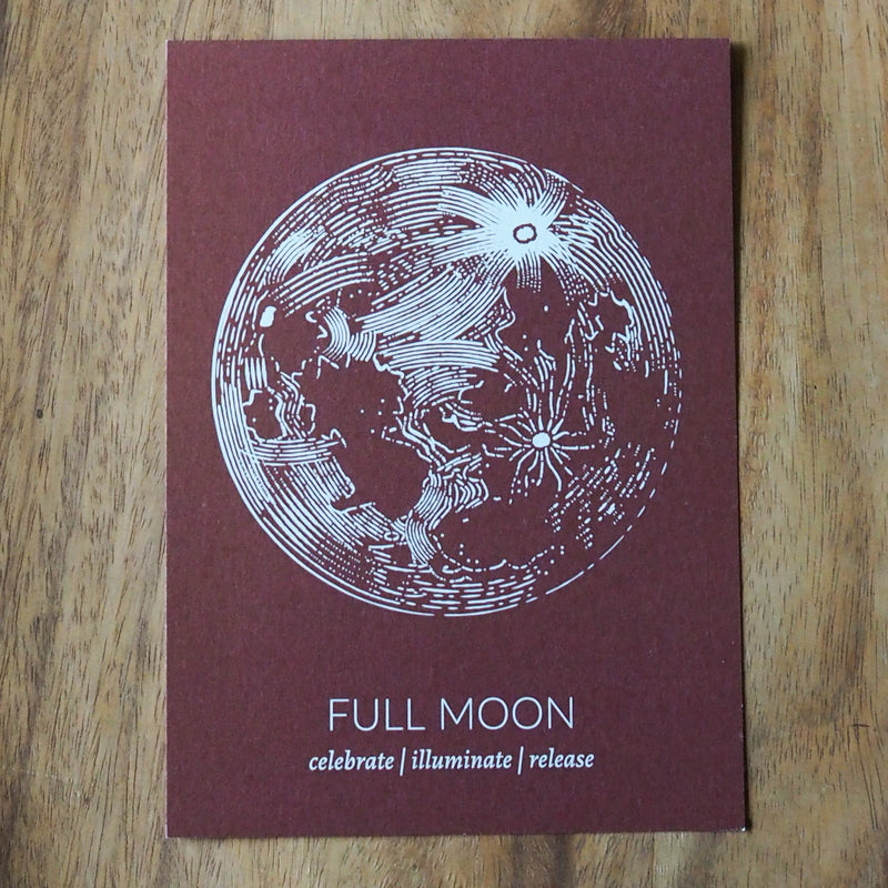 rust colored full moon lunar print on wooden background