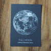 grey full moon lunar print on wooden background