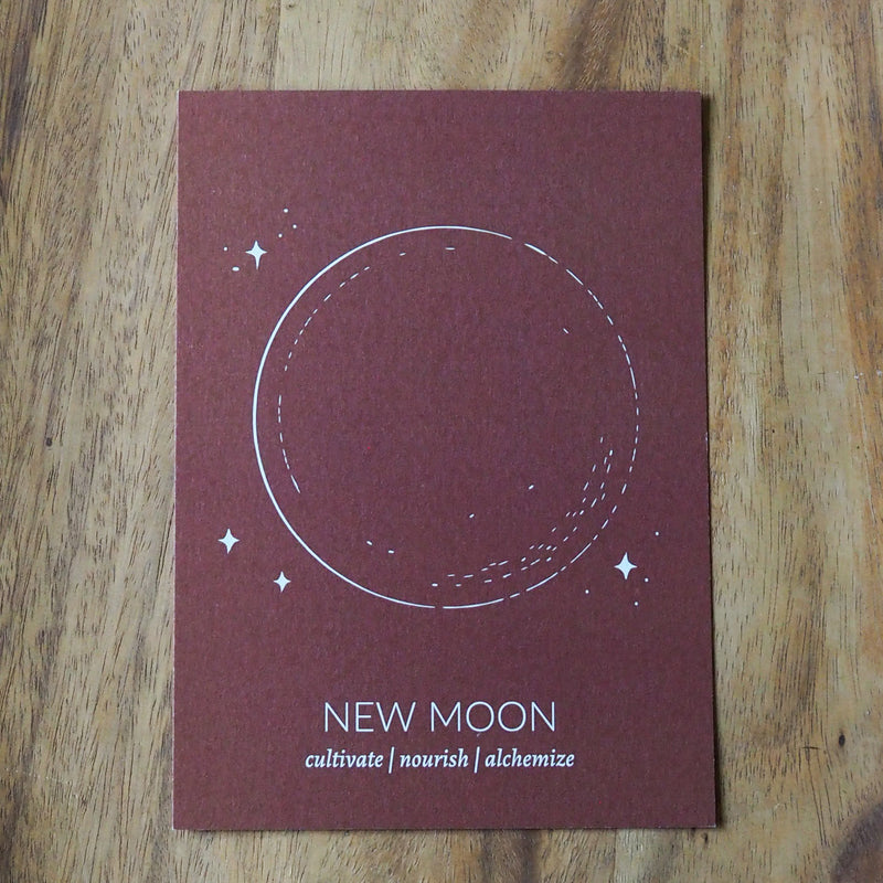 rust colored new moon lunar print on wooden background