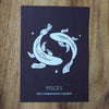 pisces zodiac astrology print on wooden background