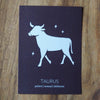 taurus zodiac astrology print on wooden background