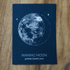 blue waning moon lunar phase print on wooden background