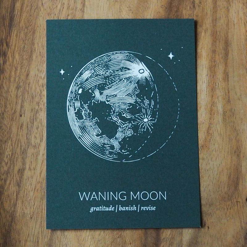 green waning moon lunar print on wooden background