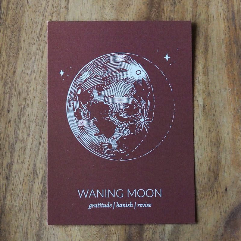rust colored  waning moon lunar phase print on wooden background