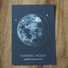 grey waning moon lunar phase print on wooden background