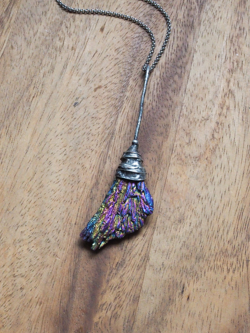 rainbow besom witches broom healing crystal talisman necklace on wooden background