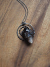 large grey healing talisman crystal statement necklace on wooden background