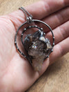 large grey healing talisman crystal statement necklace in palm of hand