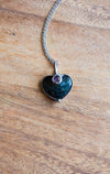 blue gemstone crystal necklace talisman on wooden background