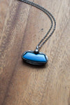 bright blue kingman turquoise gemstone healing crystal talisman statement necklace on wooden background