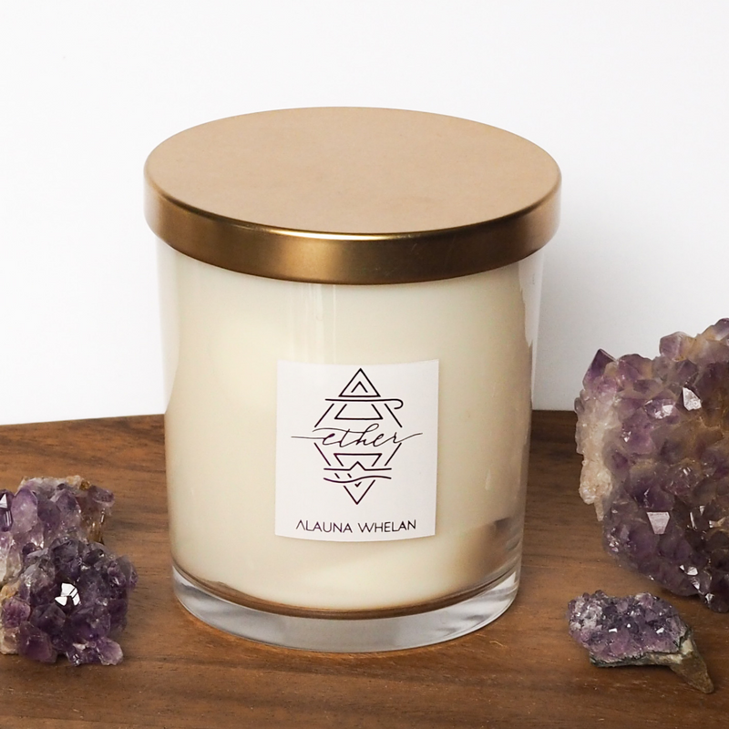 divinity ether soy candle on wooden tray with purple amethyst crystals