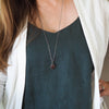 ruby healing crystal talisman necklace on woman in blue top
