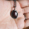 ruby healing crystal talisman necklace in palm of hand