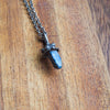 blue lapis lazuli mushroom healing crystal talisman necklace on wooden background