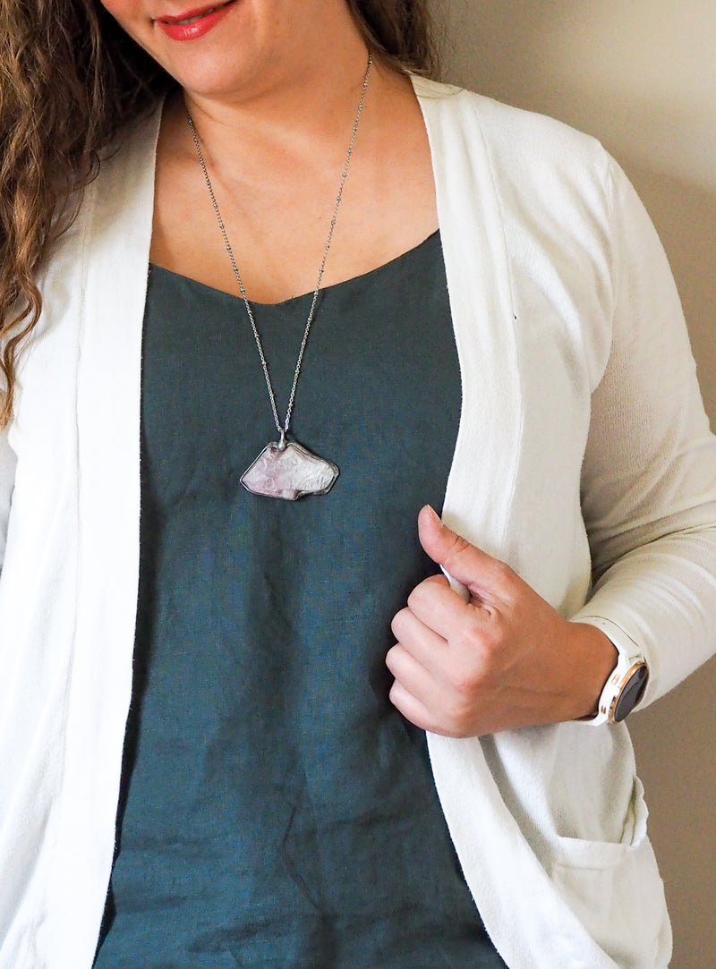 lilac purple lepidolite raw crystal talisman necklace on woman in blue top
