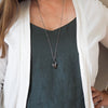 quartz and moonstone healing crystal talisman necklace on woman in blue top