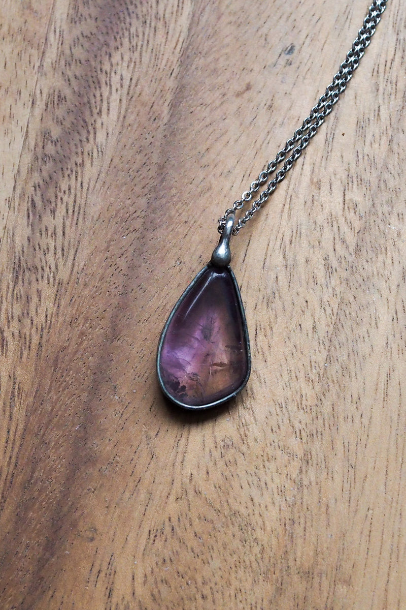 rustic purple amethyst crystal talisman necklace on wooden tray