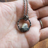 white moonstone healing crystal talisman necklace  in palm of hand