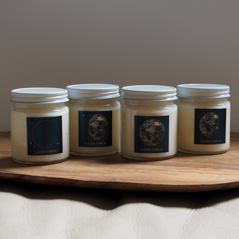 set of four lunar moon soy candles on wooden tray