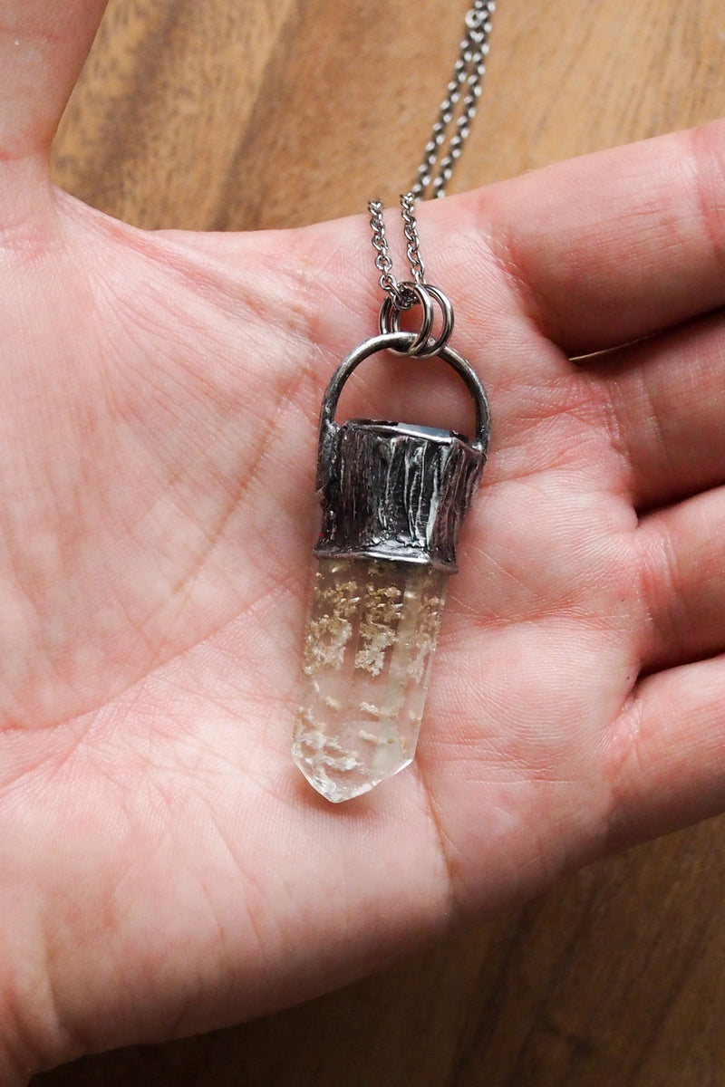 rustic chunky pale yellow crystal point layering talisman necklace in palm of hand