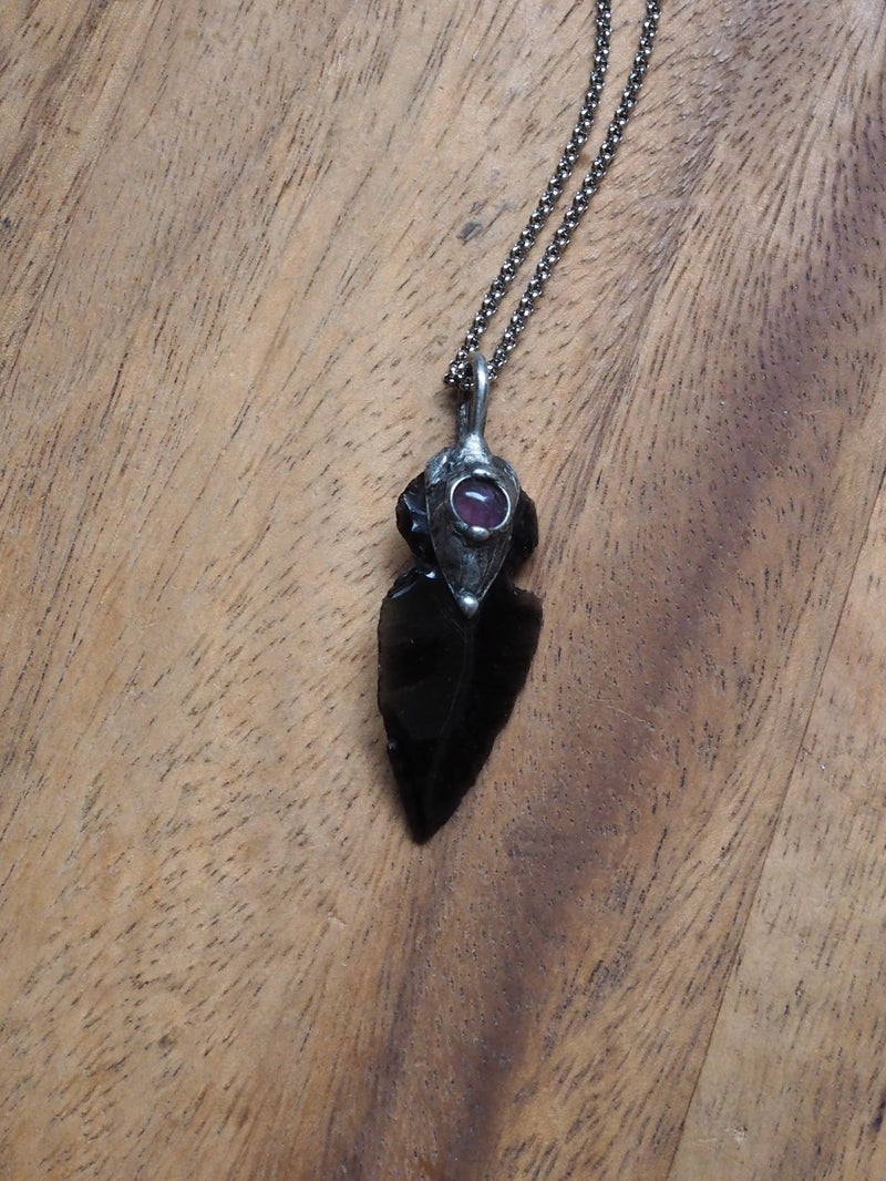 black and purple arrowhead healing crystal talisman statement necklace on wooden background