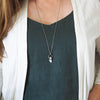 peach moonstone healing crystal talisman necklace on woman in blue top